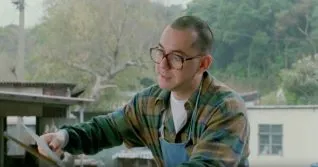 A screen shot taken from the 1993 horror film, The Untold Story. It shows a man butchering a pig with a large knife.